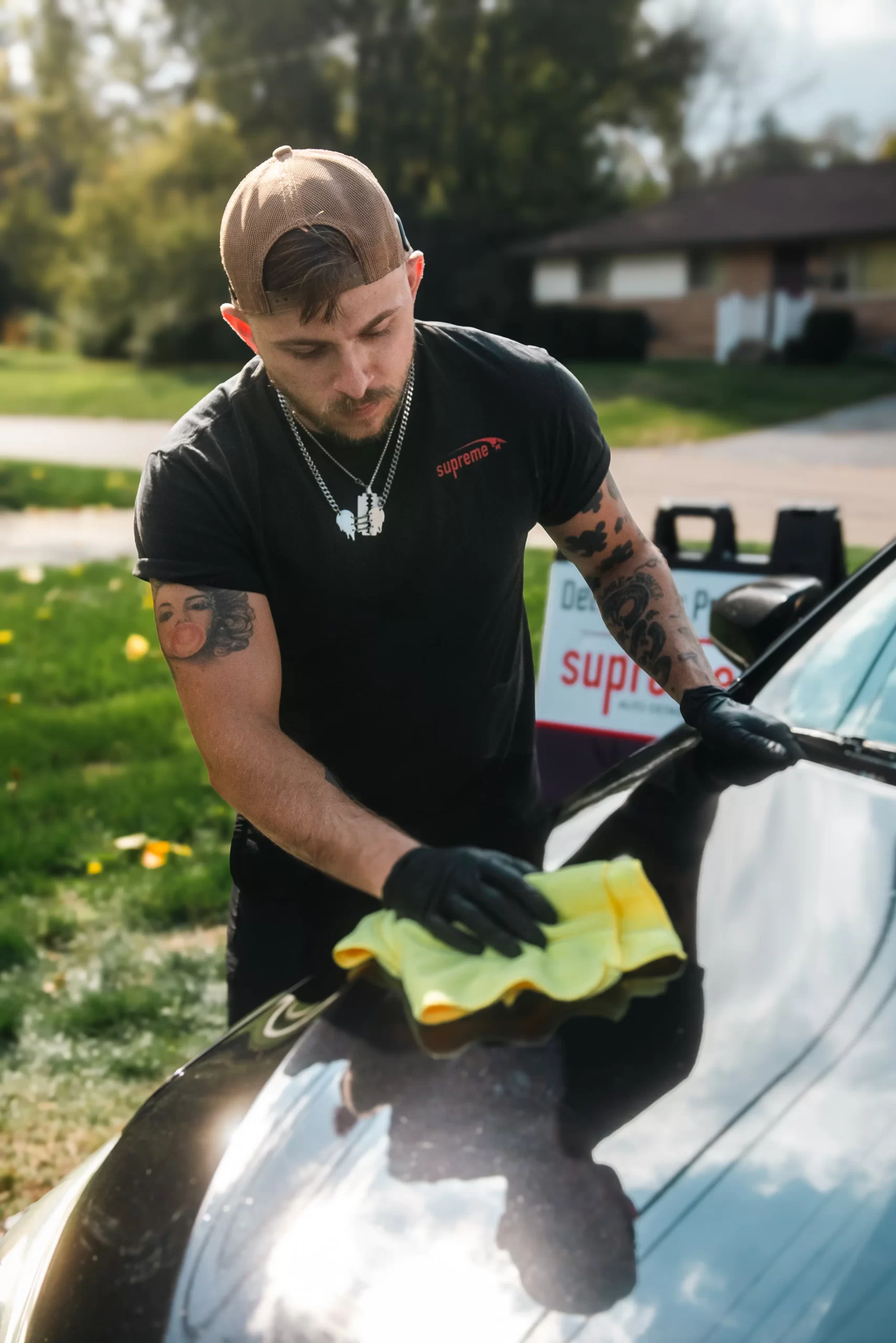 Professional auto detailer cleaning vehicle