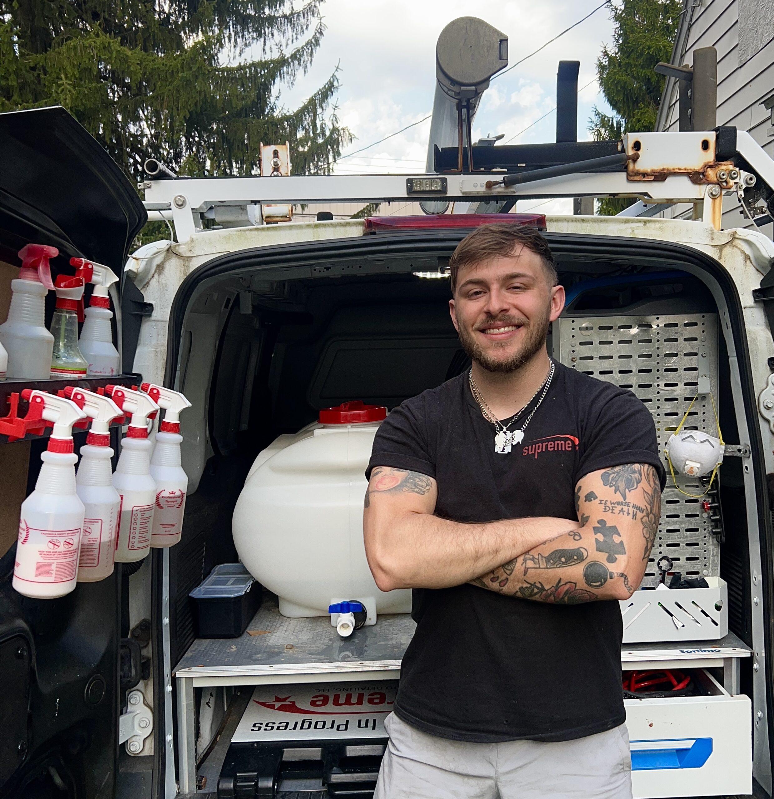 Owner of supreme auto detailing in front of their mobile detailing setup